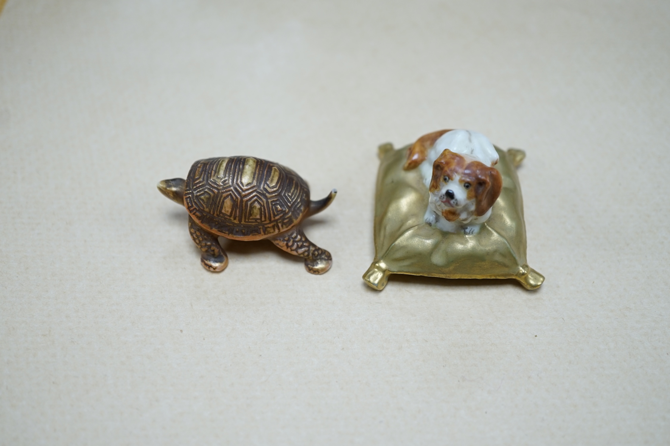 An unusual Royal Worcester miniature King Charles Spaniel sitting on cushion and tortoise, 4cm wide. Condition - fair